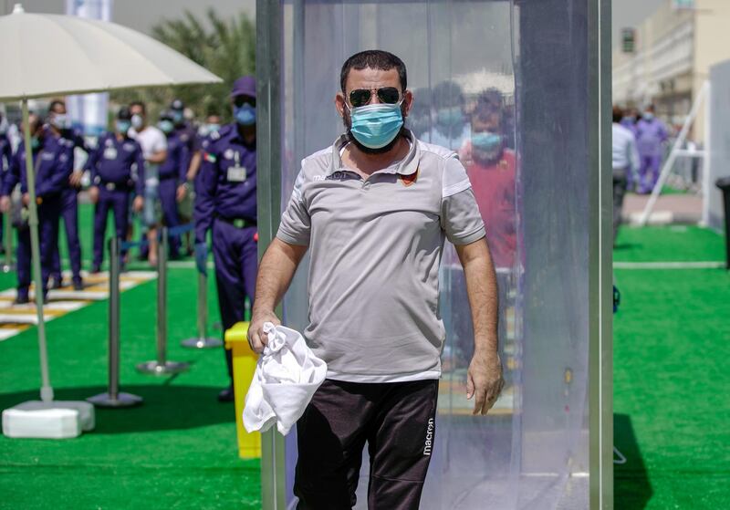 Abu Dhabi, United Arab Emirates, May 6, 2020. the new Ambulatory Healthcare Services, a SEHA Health System Facility, National Screening Project in Mussafah Industrial Area in Abu Dhabi.   -- A worker exits the Sanitising Gate before before entering the main tent screening center.
Victor Besa / The National
Section:  NA
Reporter:  Nick Webster