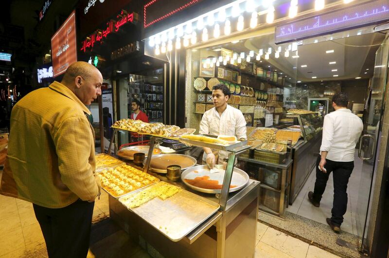 Syrians work at an eastern sweets restaurant in an area called 6 October City in Giza, Egypt, March 19, 2016. Attracting visitors from across the country, a market mostly run by Syrians fleeing the war has recently gained popularity in Giza. The area, in 6 October City, is known as 'Little Damascus' due to its large Syrian population, as well as eateries and shops selling traditional Syrian delicacies.  REUTERS/Mohamed Abd El Ghany