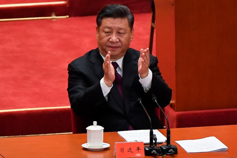 China's President Xi Jinping applauds during a celebration meeting marking the 40th anniversary of China's "reform and opening up" policy at the Great Hall of the People in Beijing on December 18, 2018. President Xi Jinping warned on December 18 that no one can "dictate" China's economic development path as the Communist Party marked 40 years of its historic "reform and opening up" policy amid a stern challenge from the United States. / AFP / WANG Zhao
