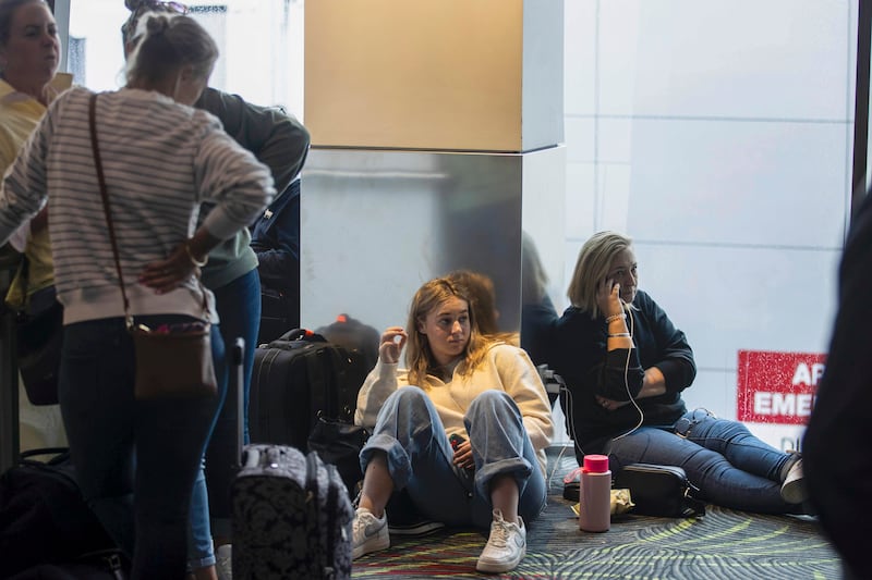 Passengers wait in departure lounges at Auckland Airport. AP