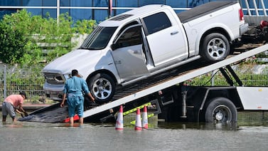 A stranded pick-up is recovered after heavy rain in Dubai on April 16. AFP