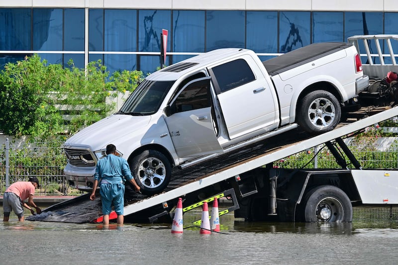 A stranded pick-up is recovered after heavy rain in Dubai on April 16. AFP