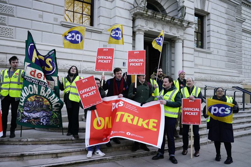 Members of the Public and Commercial Services union on the picket line outside the UK Treasury in Westminster. PA