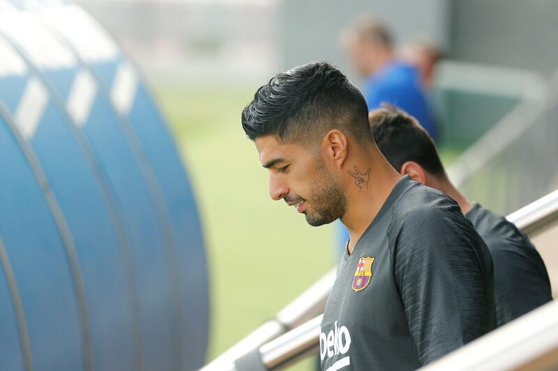 Barcelona's Uruguayan forward Luis Suarez arrives to take part in a training session at the Joan Gamper Sports City training ground in Barcelona. AFP