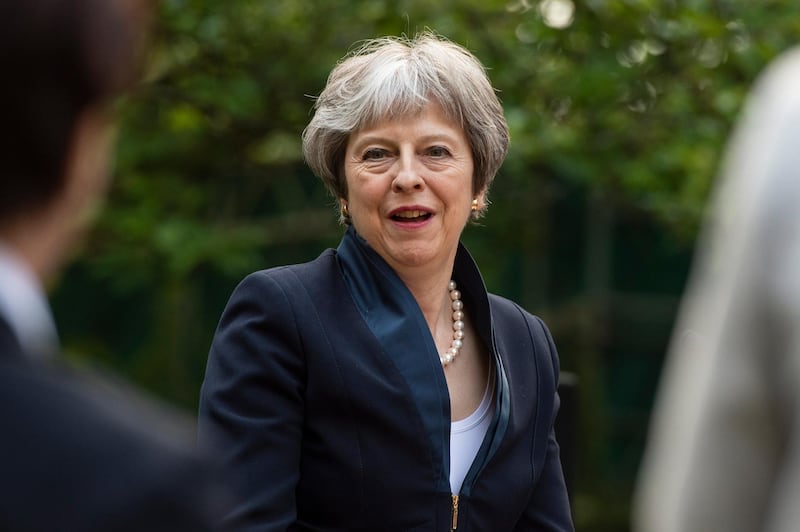 epa06758260 British Prime Minister Theresa May addresses a reception in the garden at No10 Downing Street as part of the 100th anniversary of the founding of the Royal Air Force (RAF) in Central London, Britain, 23 May 2018.  EPA/WILL OLIVER / POOL INTERNATIONAL POOL