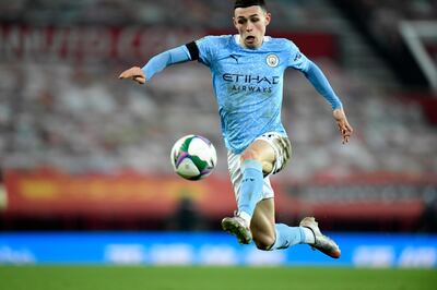 Manchester City's Phil Foden controls the ball during the English League Cup semifinal soccer match between Manchester United and Manchester City at Old Trafford in Manchester, England, Wednesday, Jan. 6, 2021. (Peter Powell/Pool via AP)