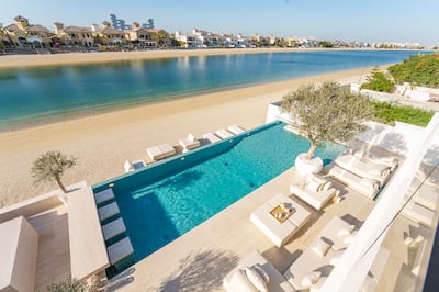 The villa has an infinity pool and its own stretch of private beach. Photo: haus & haus