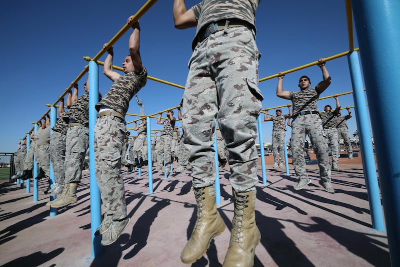Cadets go through the paces during a group pull-ups session.  EPA