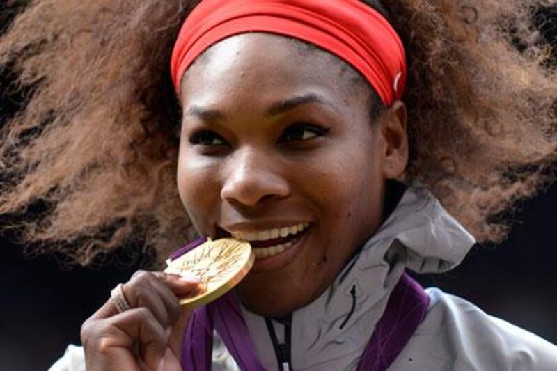 Serena Williams poses with her gold medal after defeating Maria Sharapova 6-0 6-1 at London 2012