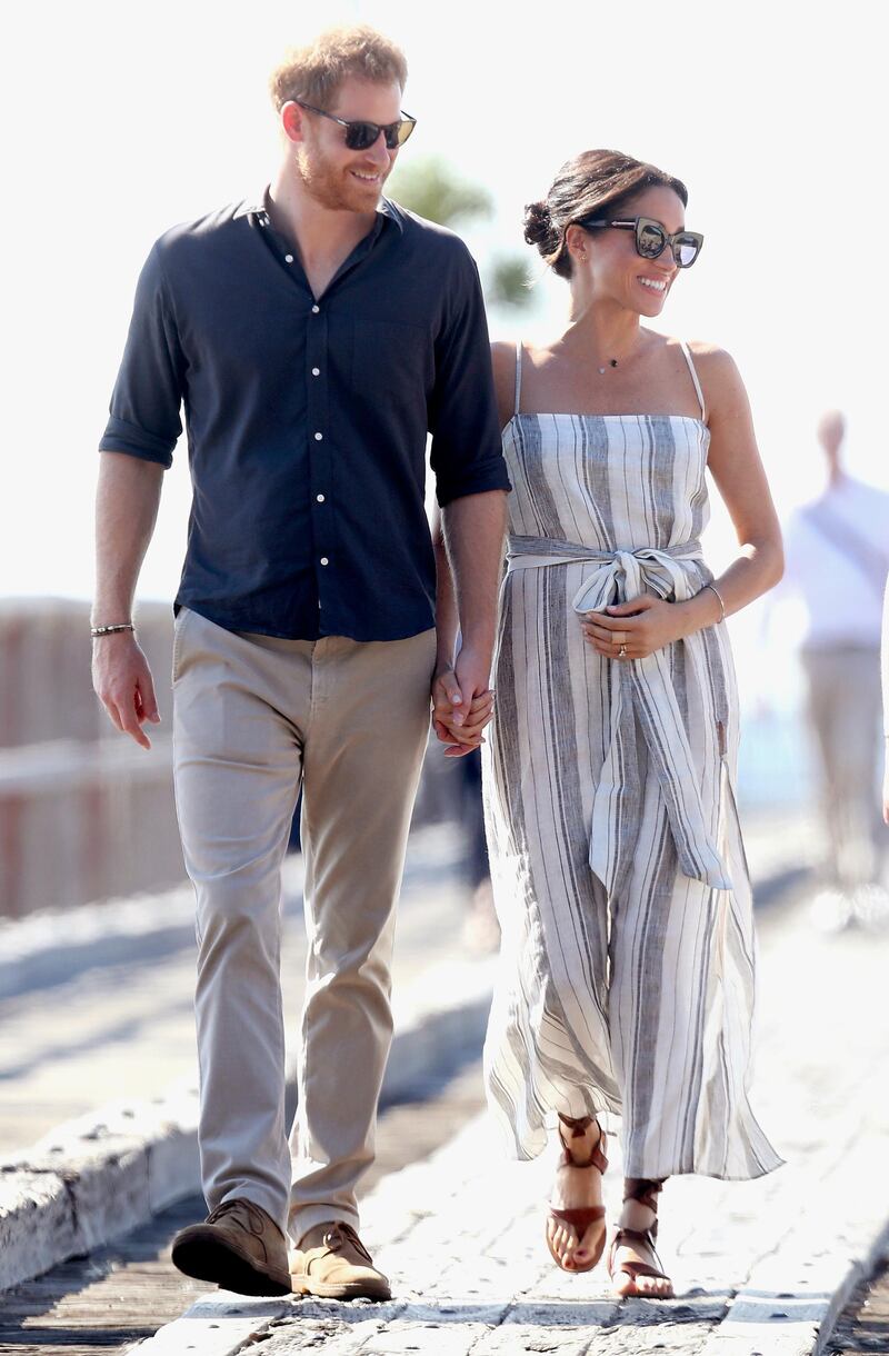 She wore a striped dress by sustainable fashion brand Reformation for a  walk along the Kingfisher Bay Jetty in Australia. Her sunglasses are by New Zealand brand Karen Walker and her sandals are by Sarah Flint.