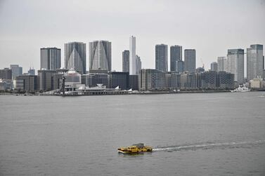 A boat sails through Tokyo bay. Japan is the latest country to announce a massive economic support package. AFP 