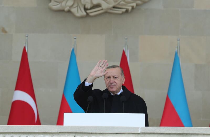A handout picture taken and released on December 10, 2020 by the Turkish presidential press service shows Turkish President Recep Tayyip Erdogan attending a military parade marking Azerbaijan's victory against Armenia in their conflict for control over the disputed Nagorno-Karabakh region, in Baku. RESTRICTED TO EDITORIAL USE - MANDATORY CREDIT "AFP PHOTO / Turkish presidential press service / Mustafa KAMACI " - NO MARKETING - NO ADVERTISING CAMPAIGNS - DISTRIBUTED AS A SERVICE TO CLIENTS
 / AFP / TURKISH PRESIDENTIAL PRESS SERVICE / Mustafa Kamaci / RESTRICTED TO EDITORIAL USE - MANDATORY CREDIT "AFP PHOTO / Turkish presidential press service / Mustafa KAMACI " - NO MARKETING - NO ADVERTISING CAMPAIGNS - DISTRIBUTED AS A SERVICE TO CLIENTS

