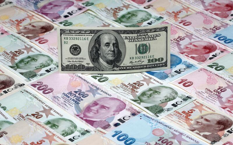 FILE PHOTO: A picture illustration shows a 100 Dollar banknote laying on various denomination Turkish lira banknotes, taken in Istanbul, Turkey January 7, 2014.  REUTERS/Murad Sezer/Illustration/File Photo