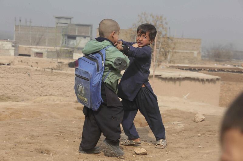 Afghan boys fight at the Kabobayan refugee camp. AP Photo