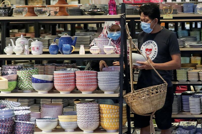 A couple wearing face masks shops at a mall as people prepare for the upcoming Eid al-Fitr celebrations, the religious festival that marks the end of the fasting month of Ramadan amid the ongoing coronavirus COVID-19 pandemic in Kuala Lumpur, Malaysia.  EPA