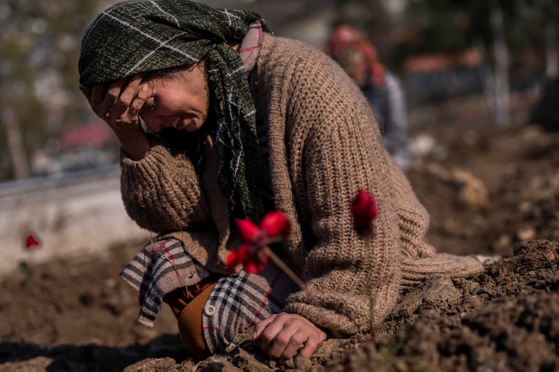 A woman mourns a relative during the burial of one of the earthquake victims in Antakya, southeastern Turkey. AP Photo