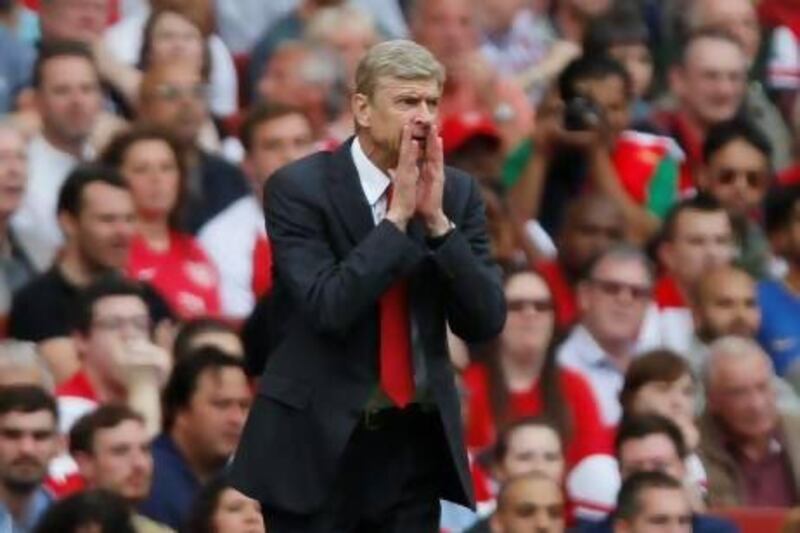 Arsenal manager Arsene Wenger reacts as he watches his team play against Tottenham Hotspur. Sang Tan / AP Photo