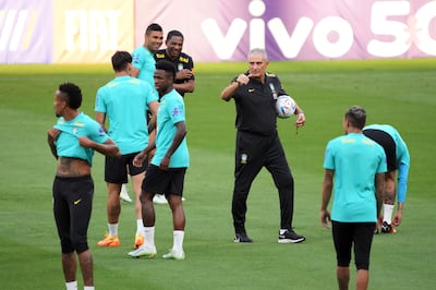 Brazil head coach Tite, centre, instructs his players during a training session in Tokyo in June, 2022. AP 