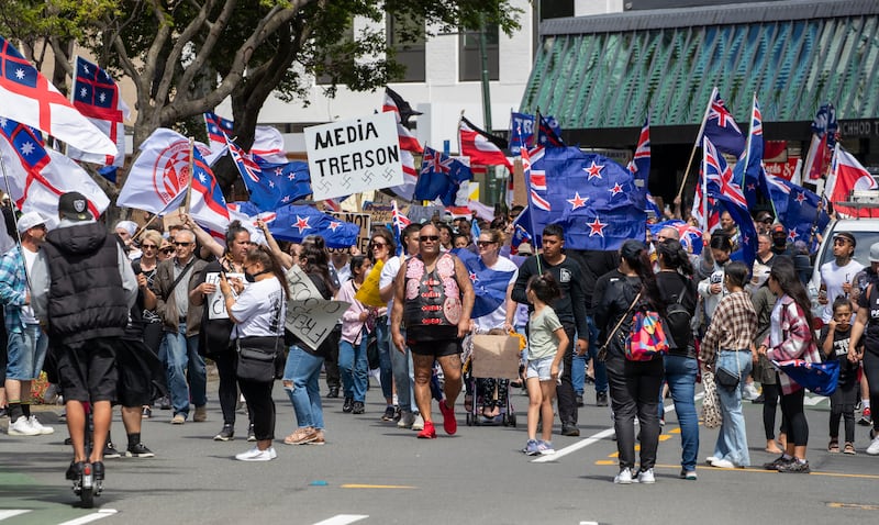 Freedom and Rights Coalition demonstrators march along Lambton Quay before gathering at Parliament, in Wellington, New Zealand, on Tuesday, November 9, 2021. NZ Herald via AP