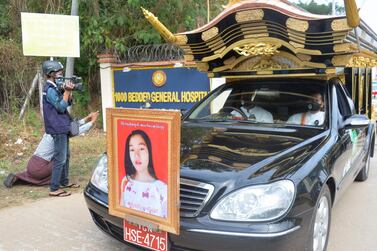 A portrait of young protester Mya Thwate Thwate Khaing is pictured on a car in a convoy at her funeral service, after she died following being shot during a rally against the military coup, in Naypyidaw. AFP