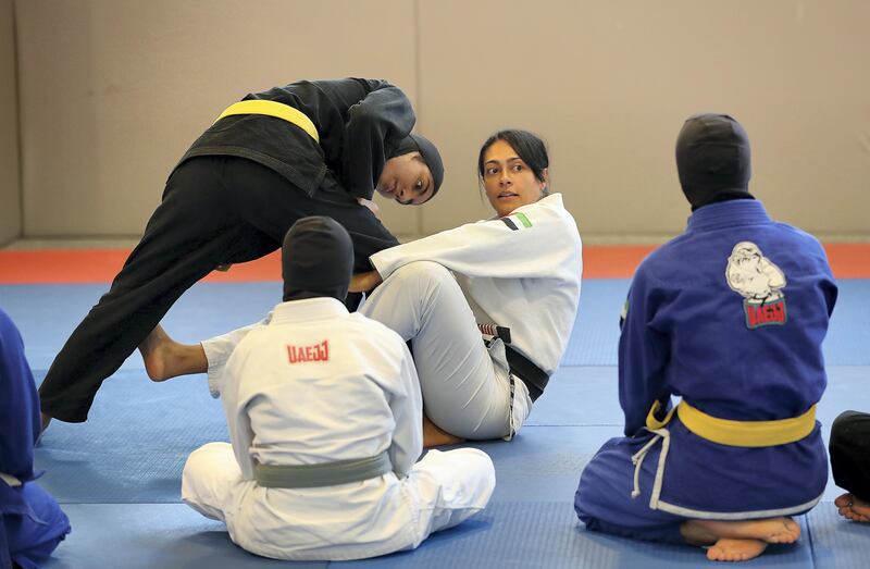 ABU DHABI , UNITED ARAB EMIRATES , AUG 27 – 2017 :-  Rosalind Ferreira , coach ( center ) giving tips during the training of UAE women’s junior national Jiu Jitsu team at the Arena at Zayed Sports City in Abu Dhabi. ( Pawan Singh / The National ) Story by Amith Passela