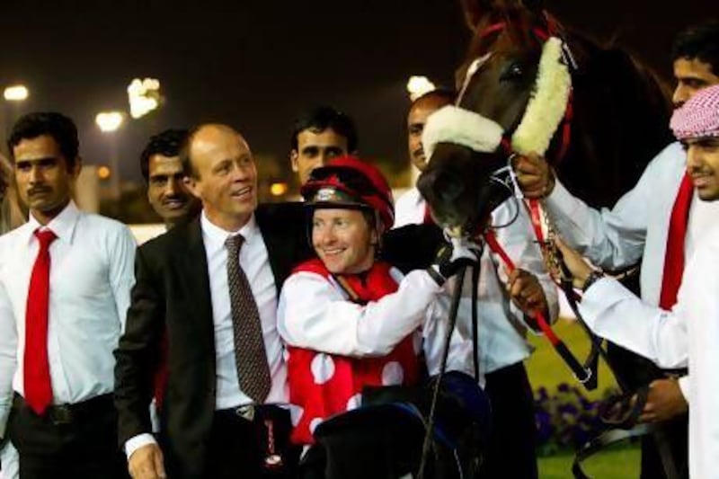 Trainer Ernst Oertel, centre left, visited the winner's circle four times on Sunday night at the Abu Dhabi Equestrian Club, with and jockey Tadhg O'Shea making the trip with him three times, once aboard Skoop.