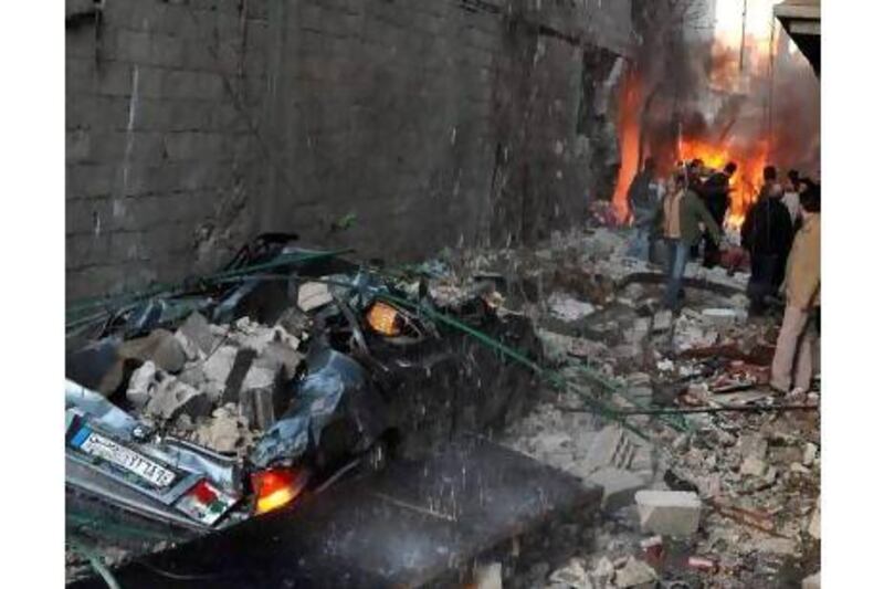 Syrians inspect the damage from one of Wednesday's car bombings. A reader says the killing must stop. AFP / STR