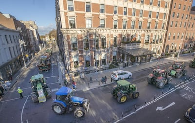 A convoy of farmers driving tractors through Dublin city centre in a protest against the government's climate plan. PA

