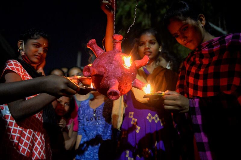 Students from the government girls hostel prepare to burn a Covid-19 coronavirus model during Diwali.  AFP