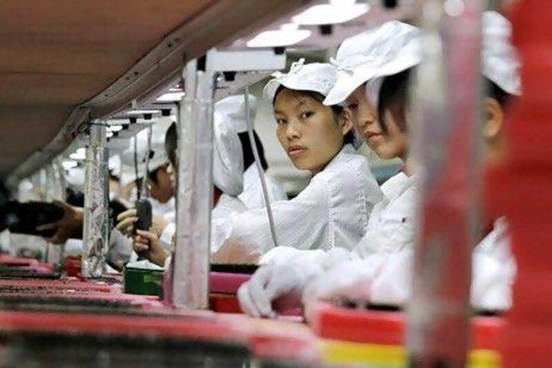 Apple outsourced manufacture of iPhone and iPad tablet computer to Foxconn's factories in Asia and Latin America. Bobby Yip / Reuters