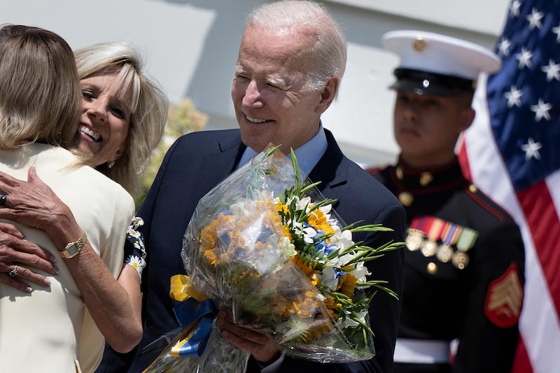 The president watches as US first lady Jill Biden greet Ukrainian first lady Olena Zelenska on July 19. AFP