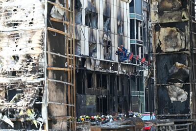 Rescue teams search the charred structure of the Grand Diamond City hotel and casino in Poipet.  AFP