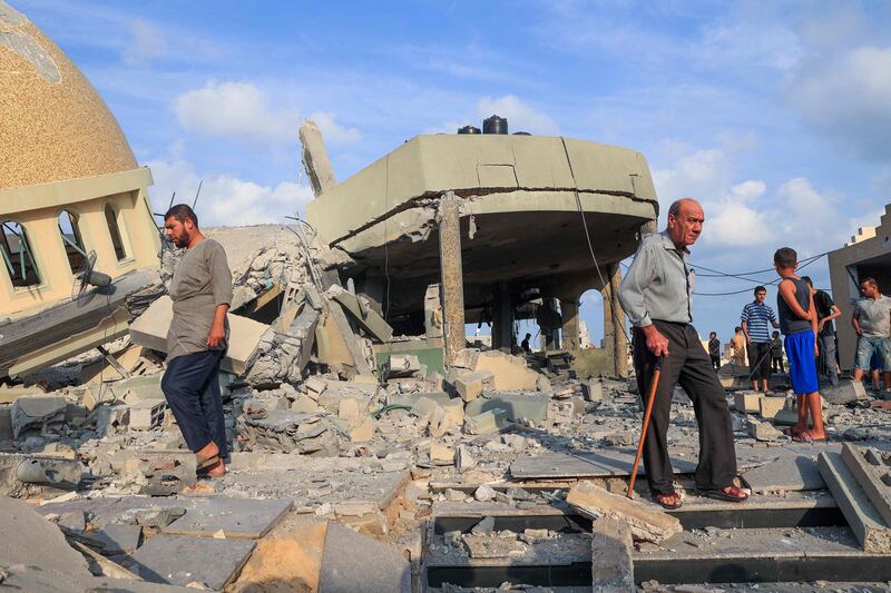 People near a mosque destroyed in Israeli airstrikes in Khan Yunis, southern Gaza Strip. AFP