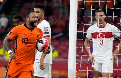Memphis Depay of the Netherlands, left, celebrates scoring his side's fourth goal during the World Cup 2022 qualifier against Turkey. AP