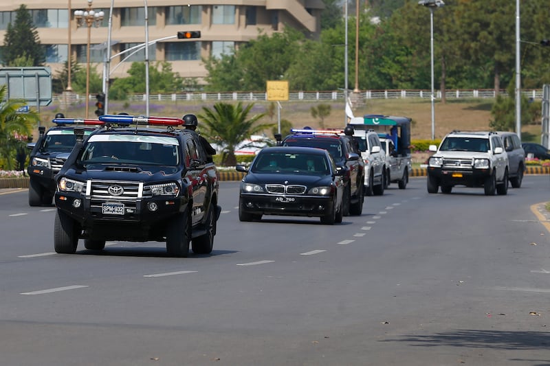 A police convoy escorts Pakistani politician Asif Ali Zardari, the former president, as he arrives to attend National Assembly session. AP