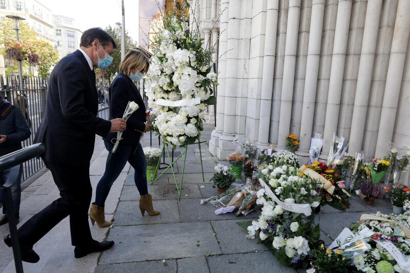 Mayor of Nice Christian Estrosi and his wife Laura pay tribute to the victims of a deadly knife attack at the Notre Dame church in Nice. Reuters