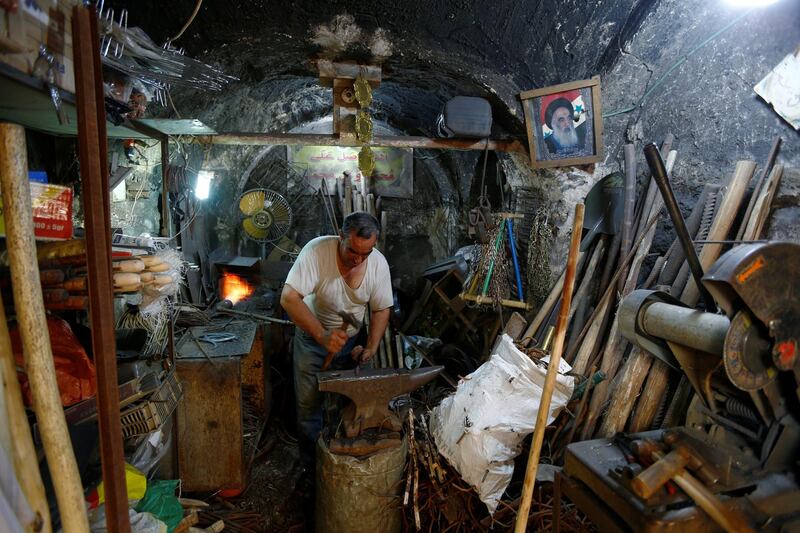 A man works at a shop as a curfew is eased in Najaf, Iraq. Reuters