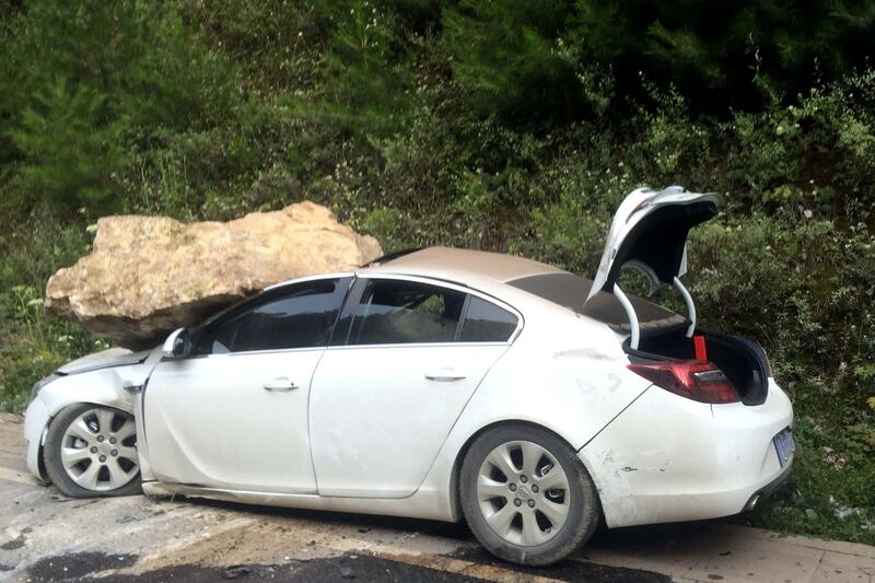 A car, damaged by a rock during an earthquake, is seen in Jiuzhaigou in China's southwestern Sichuan province.  AFP