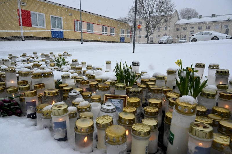Candles and flowers placed in front of Viertola School in tribute to victims in Vantaa after a 12-year-old opened fire. AFP