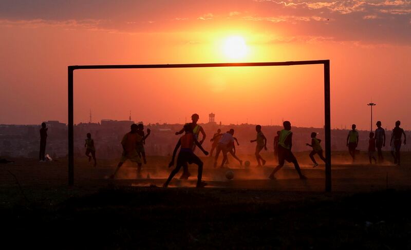 Locals playing football in Soweto, South Africa, on Wednesday, September 15. Reuters