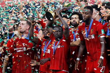 Liverpool's Sadio Mane and teammates celebrate winning the Club World Cup with the trophy. Reuters