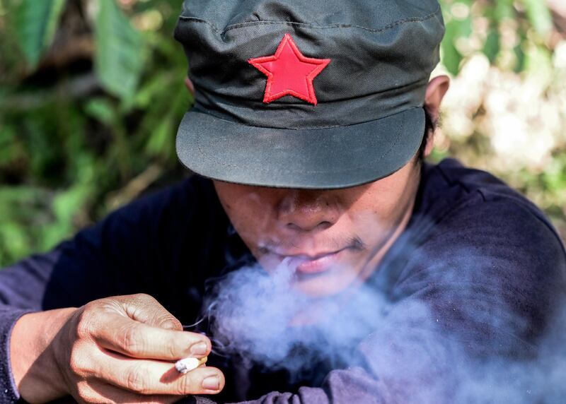 A fighter of the New People's Army-Melito Glor Command smokes a cigarette at an undisclosed location in the mountains of Sierra Madre, Philippines. EPA
