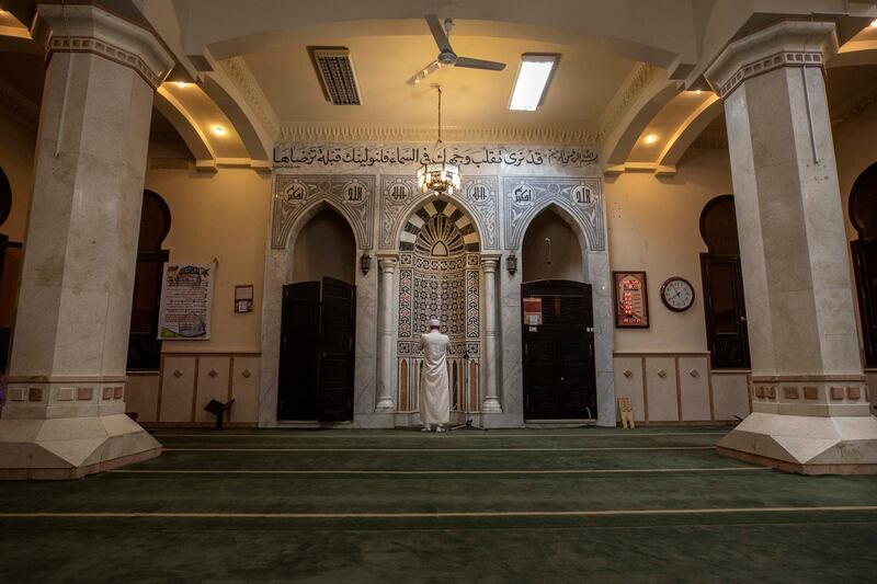 An Imam makes the Adaan call to prayer inside an empty mosque after the government banned all religious activities due to the coronavirus outbreak in Cairo. AP