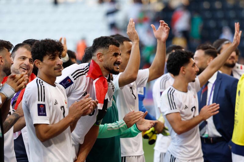 Iraq's players celebrate with their supporters. AFP