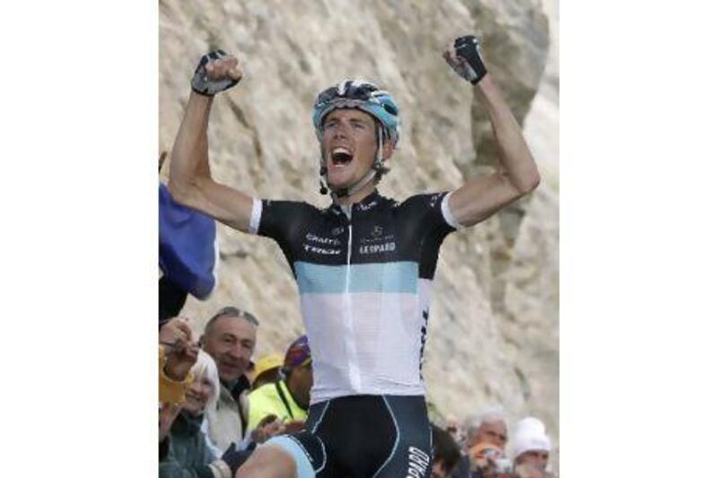 Andy Schleck celebrates his victory as he cycles past the finish line to win the 18th stage of the Tour de France yesterday.