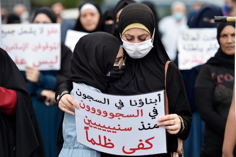 A girl hugs her mother during a protest for relatives and families of Islamic prisoners at Roumieh prison as they carry placards calling for clemency for their relatives in the coastal town of Sidon, Lebanon. EPA