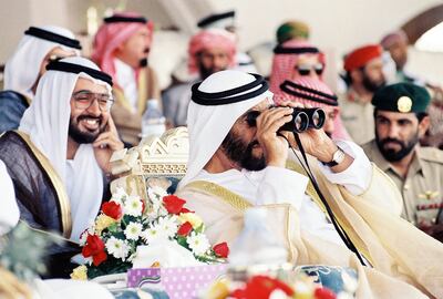 The late Sheikh Zayed and Sheikh Mohamed bin Zayed attend the final of the Arabian Camel Festival at Al Wathba Racetrack on April 26, 1991. Photo: National Archives
