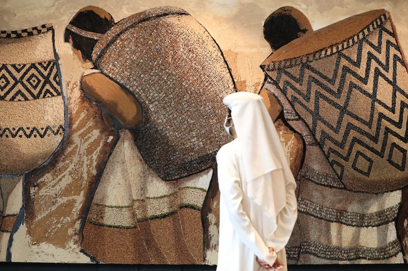 A visitor to the Paraguay Pavilion looks at artwork made from UAE seeds by Koki Ruiz. Photo: Expo 2020 Dubai