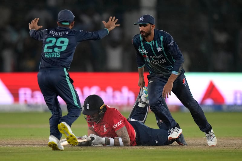 Shan Masood, right, and Mohammad Haris celebrate after England's Reece Topley is run out to seal Pakistan's victory in the fourth Twenty20 match in Karachi on September 25, 2022. AP