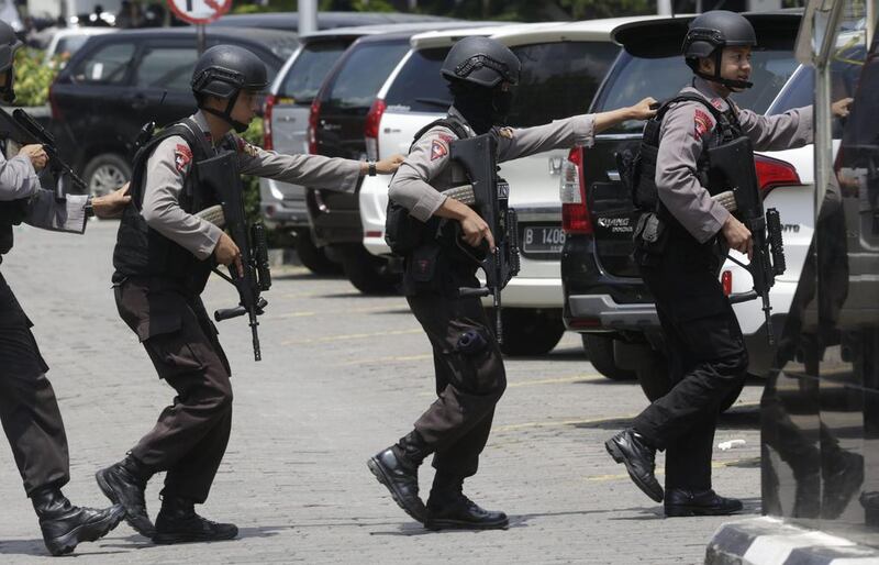 Police officers take their position near the site where an explosion went off in Jakarta. Dita Alangkara / AP Photo